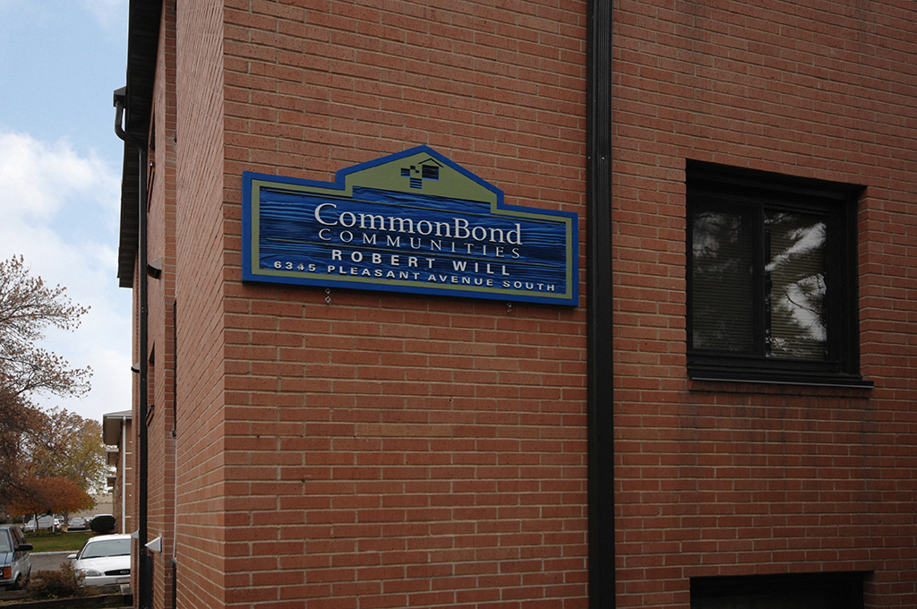 a sign on the side of a brick building